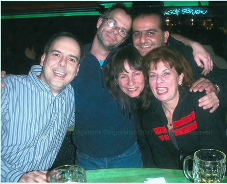 Paul The Rock God posing with a group of cheerful people at Karaoke