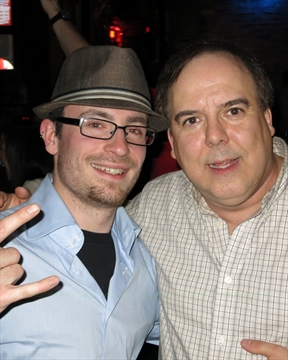 Paul The Rock God socializing with another fan at a karaoke bar