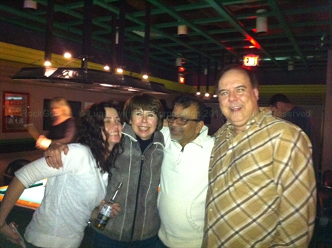 Paul The Rock God posing with a different large group at Karaoke