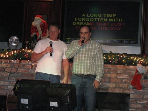 Paul The Rock God sharing a microphone singing a duet with a fan